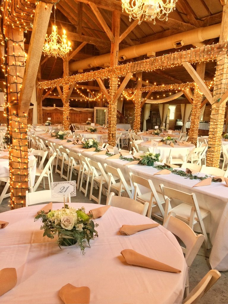Barn wedding reception set for dinner
