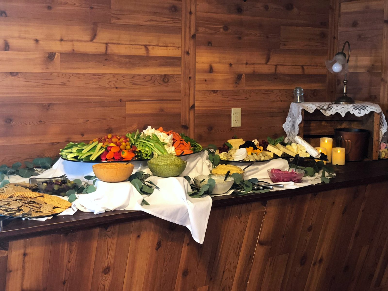Crudité, cheese and dip display on a draped table